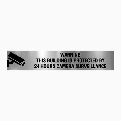 THIS BUILDING IS PROTECTED BY 24 HOURS CAMERA SURVEILLANCE SIGN
